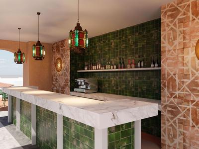 Area bar moderna con piastrelle verdi, bancone in marmo e lampade decorative sospese.