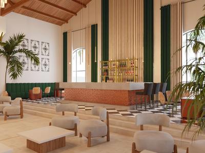 Area lounge dell'hotel luminosa con soffitti alti, piante e posti a sedere comodi.