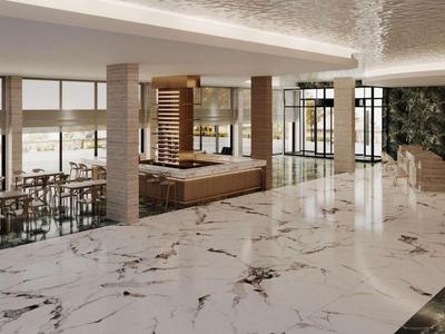 Spacious hotel lobby with white marble flooring and modern seating areas.