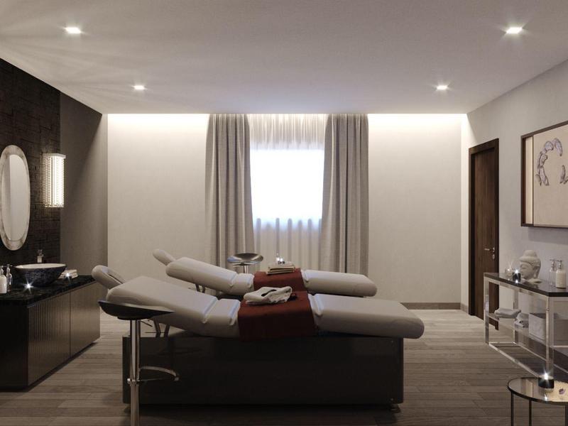 Moderne, minimalistische hotelkamer met twee ligbedden en gedempt licht.