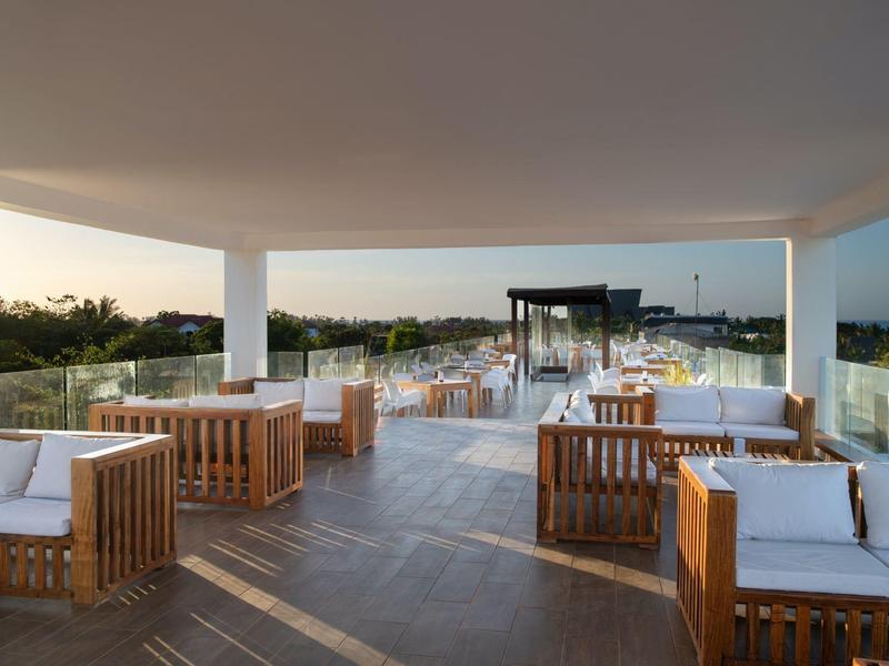 Terrazza sul tetto aperta con mobili in legno e vista sul paesaggio verde