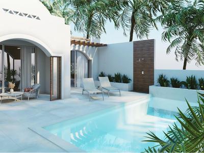 Nowoczesny zewnętrzny basen z leżakami, roślinami i białą architekturą pod palmami.