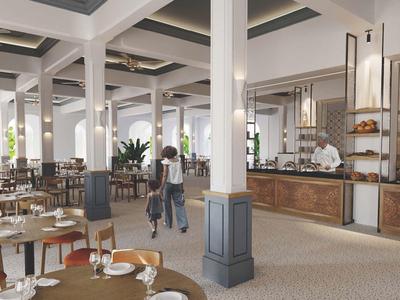 Nowoczesna restauracja z nakrytymi stołami i gośćmi w eleganckim otoczeniu.