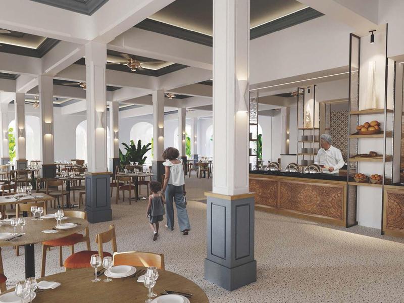 Nowoczesna restauracja z nakrytymi stołami i gośćmi w eleganckim otoczeniu.