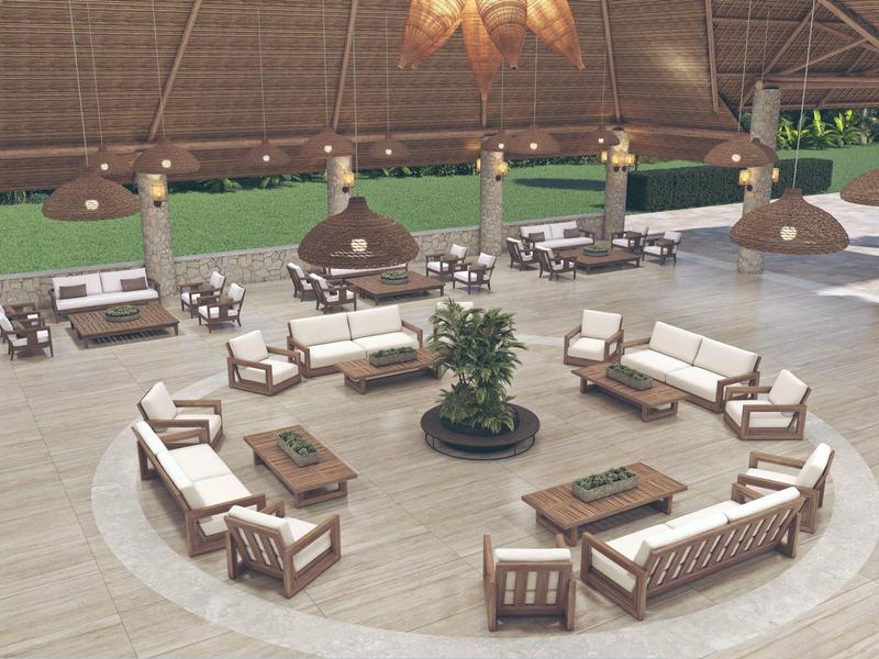 Großer offener Sitzbereich mit runden weißen Sofas und Pflanzen in einem tropischen Resort.