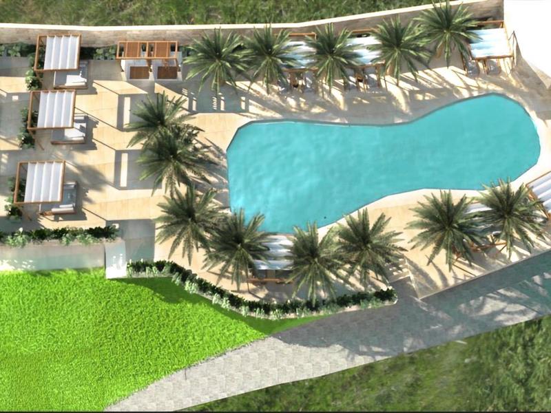 Blaue Poollandschaft mit Liegestühlen, Palmen und grünem Rasen auf hellen Steinplatten.