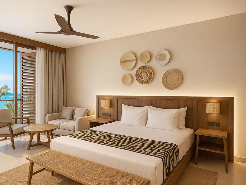 Camera d'hotel elegante con grande letto, decorazioni in vimini e vista sul mare.