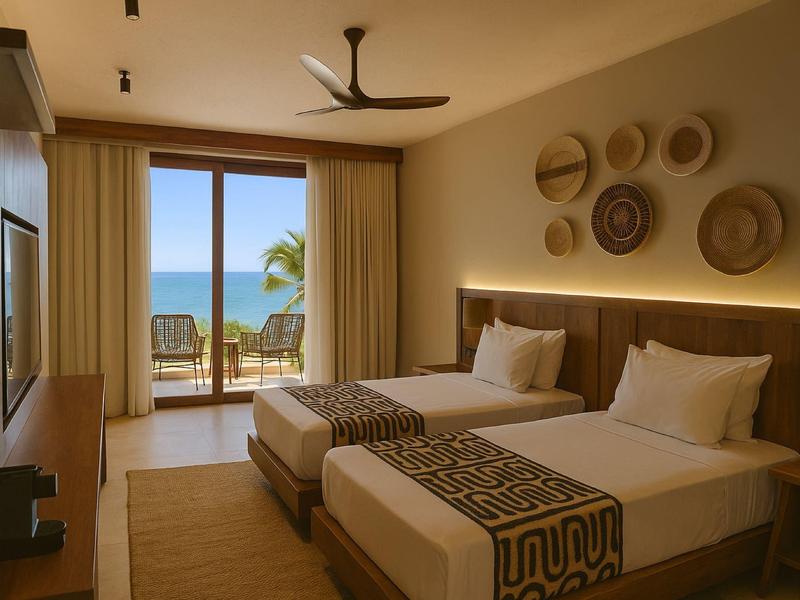 Camera d'hotel moderna con due letti singoli e vista sul mare da grandi finestre.