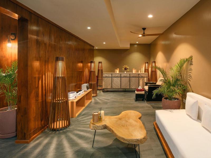 Modern hotel lobby area with wood paneling and cozy seating furniture.