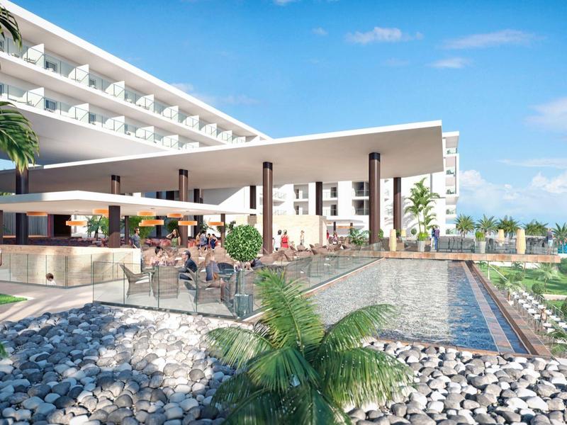 Nowoczesny hotel z basenem na zewnątrz, tarasem i widokiem na morze w słoneczny dzień.