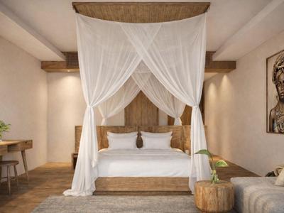 Camera da letto con letto a baldacchino, mobili in legno e decorazioni sobrie in toni caldi.